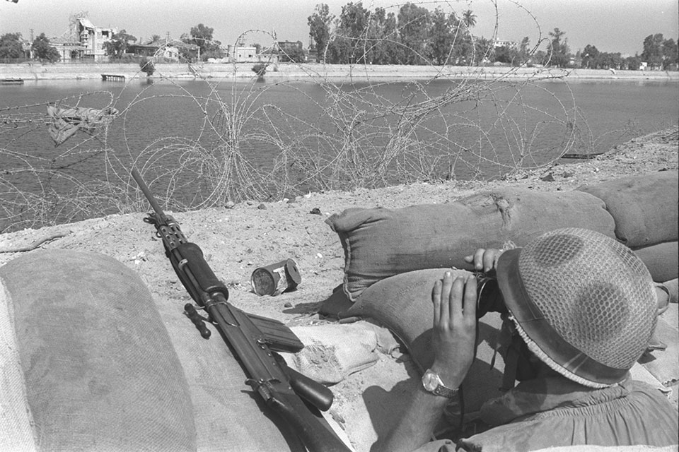 War of Attrition. Israeli soldier looking across th Suez Canal